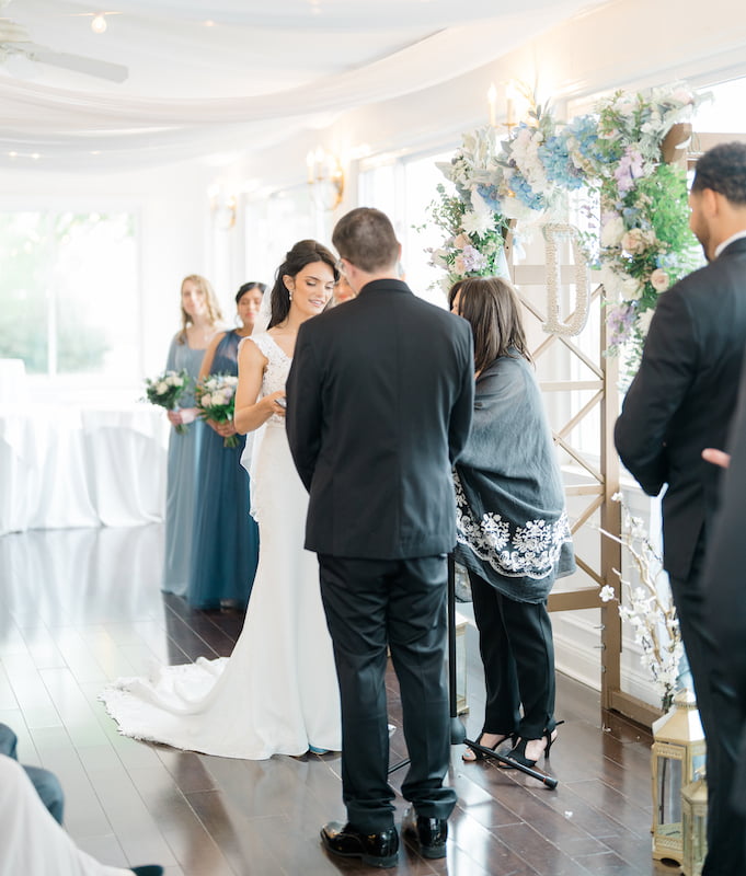 A bride and groom exchange vows in a wedding ceremony officiated by a long island officiant.