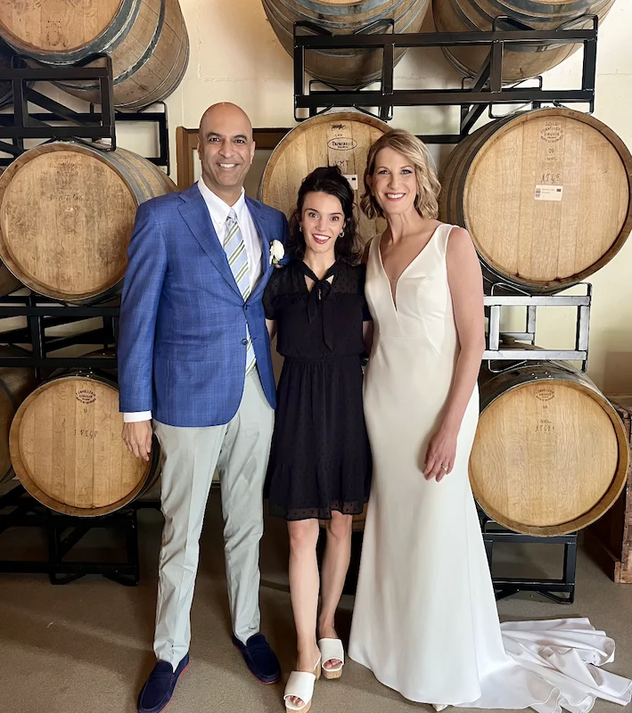 Three people posing for a photo in front of long island wedding officiants.